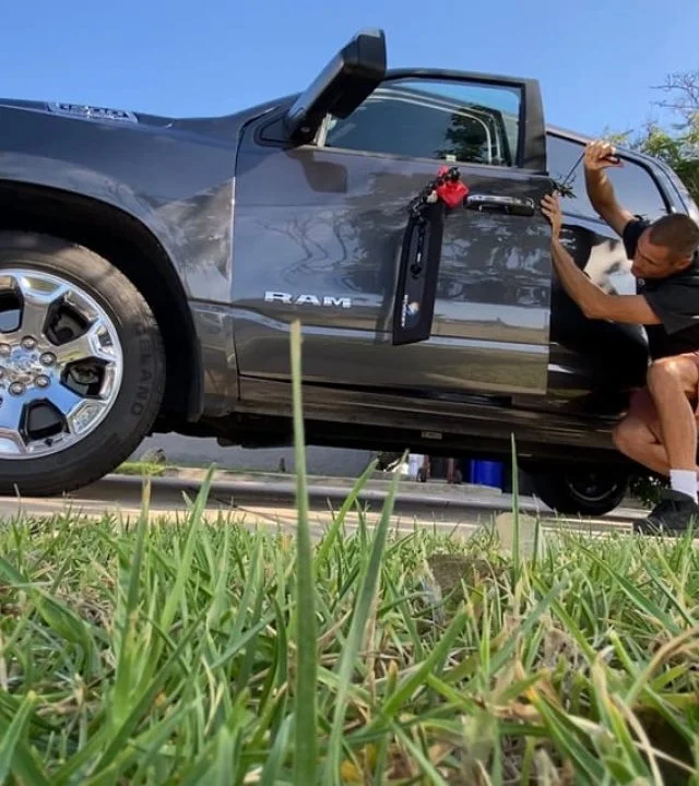 Technician repairing a Ram truck door at the roadside